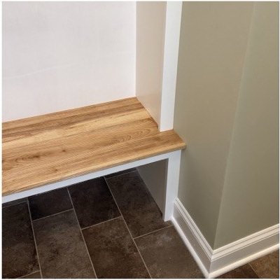 The bench top running wall to wall above open shoe storage.