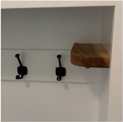 Hook rail with heavy black iron hooks and a floating valet tray at the end of the run.