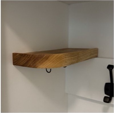 A floating hardwood valet tray mounted above the hook rail, with a key hook underneath.